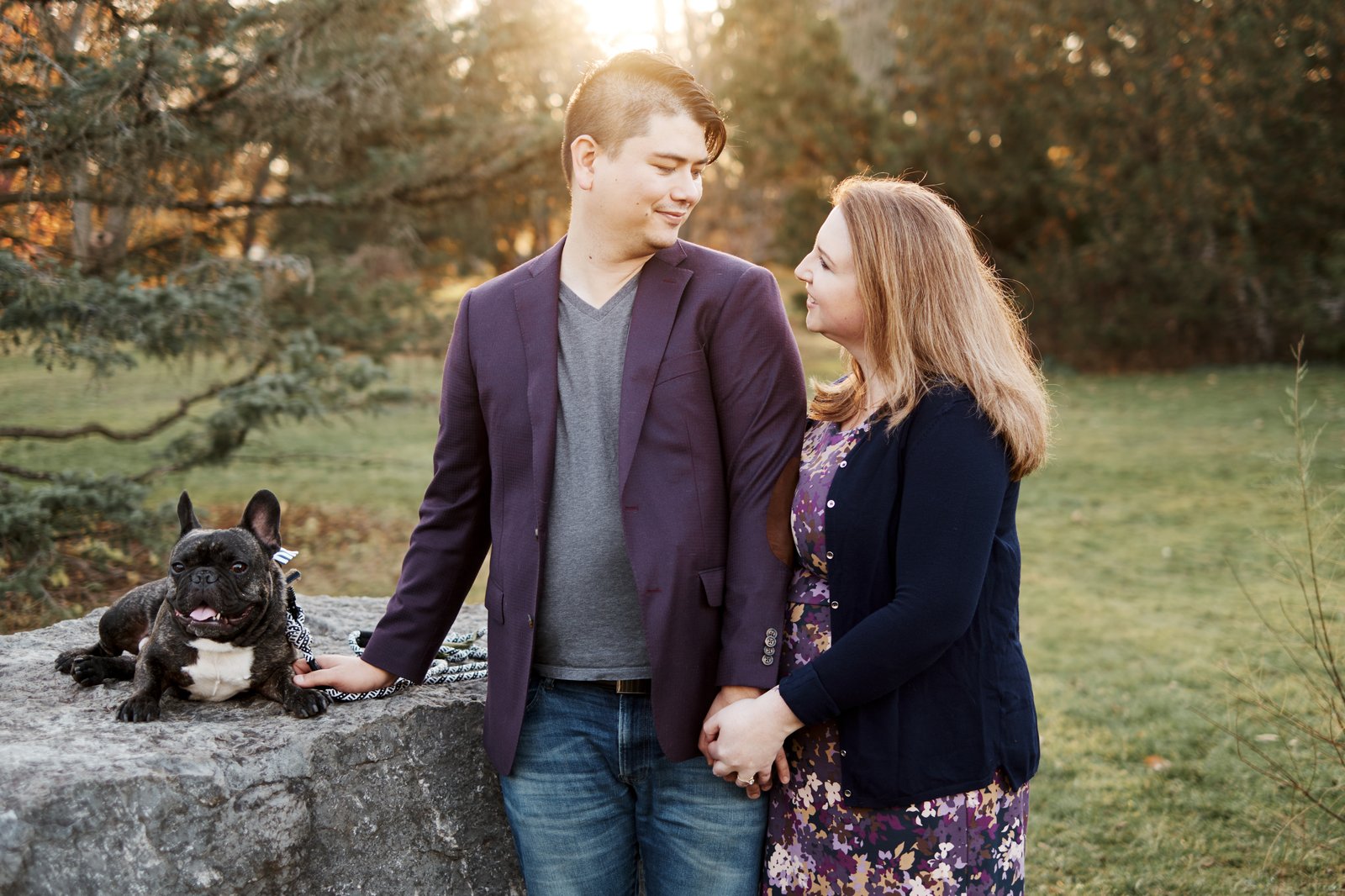 Kristopher Wong with his partner Anna and their French bulldog, at golden hour outdoors